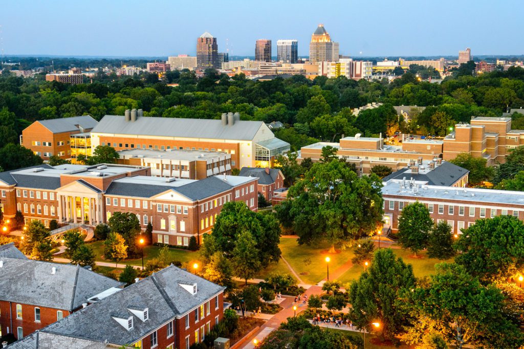 Aerial view of Greensboro, NC with the downtown skyline in the distance